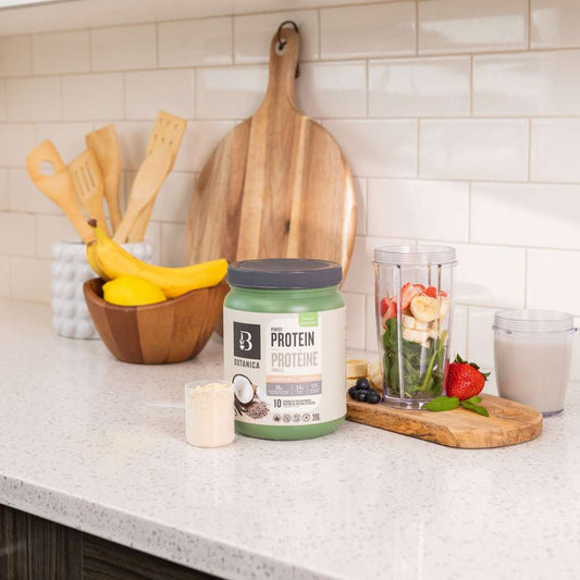 A tub of Perfect Protein and smoothie ingredients on a kitchen counter
