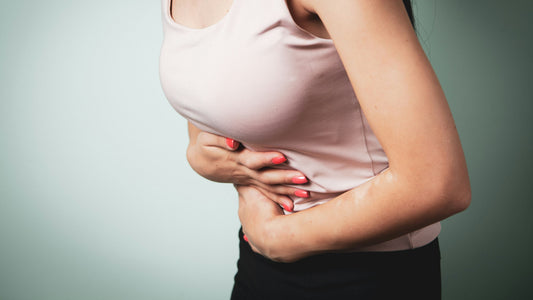 Woman clutching her stomach in discomfort