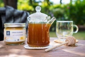 Overhead shot of teappot of Gluten free and vegan Hot Golden Turmeric Tea made with Botanica Turmeric Golden Mylk.