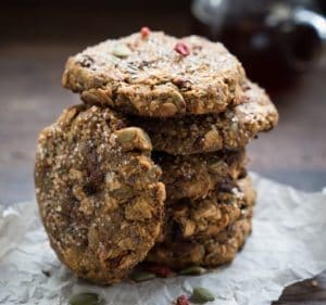 A side shot of vegan and gluten free High-Fibre Energy Cookies made with Botanica Vanilla Protein Powder and topped with pumpkin seed and goji berries
