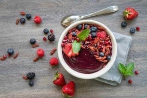 Gluten and Vegan Beetroot Berry Smoothie Bowl made with Botanica Perfect Greens Berry topped with goji berry, hemp seeds, chia seeds and berries.