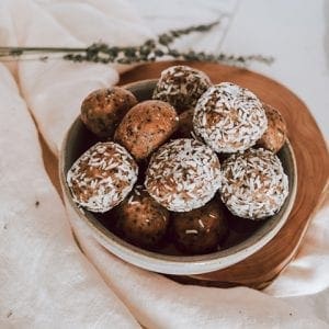 Turmeric Golden snack bites piled in a bowl garnished with shredded coconut