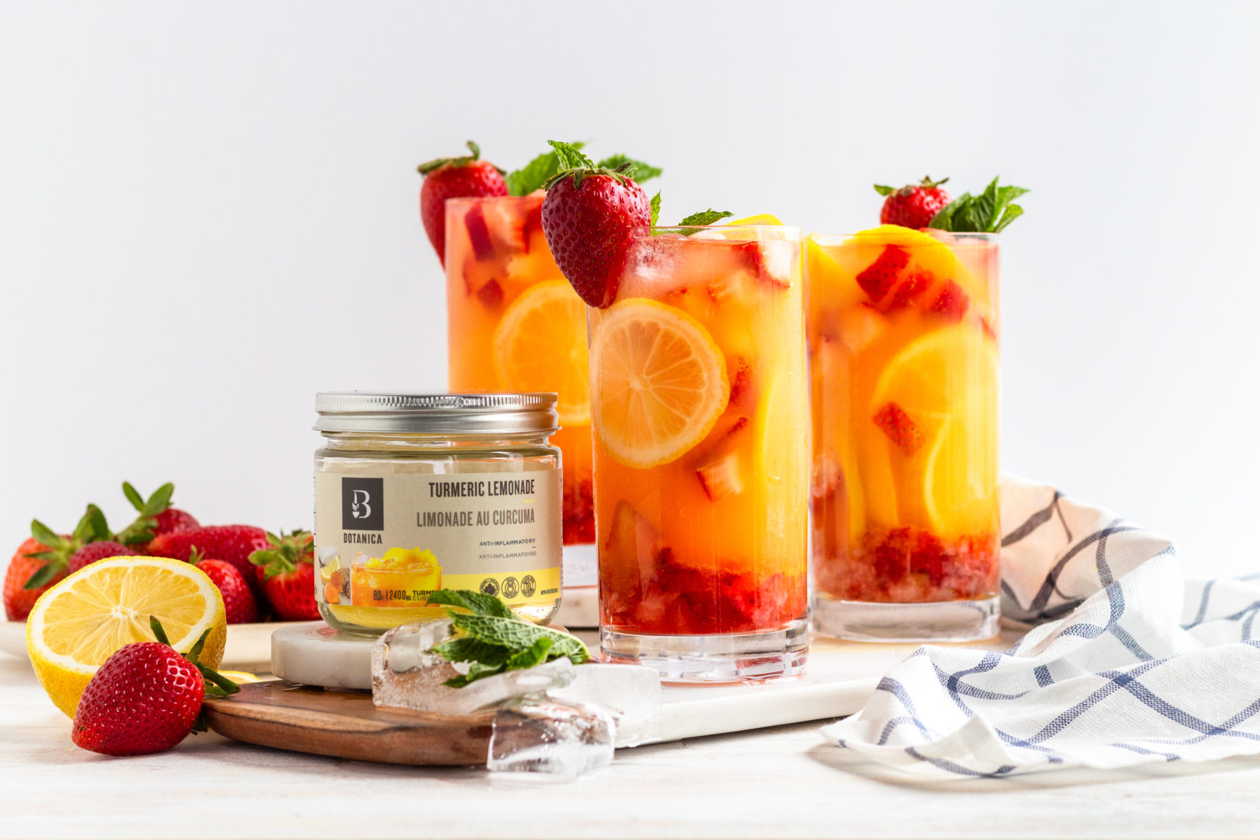 Strawberry lemonade spritz made with Botanica sweetened turmeric lemonade. refreshing summer drink. vegan, gluten-free,