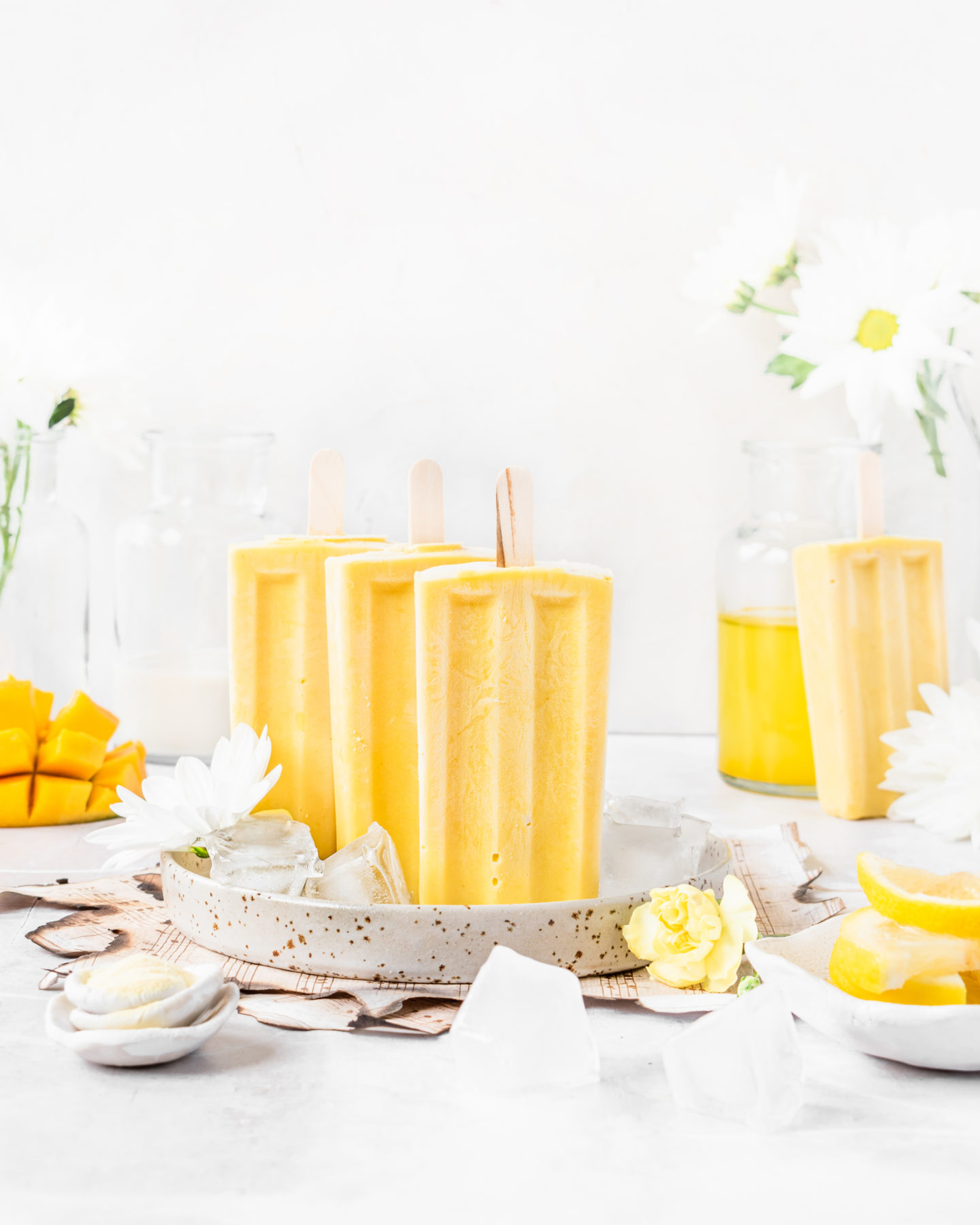 Creamy mango lemonade popsicles made with Botanica's Turmeric Lemonade powder. Refreshing, summer treat 