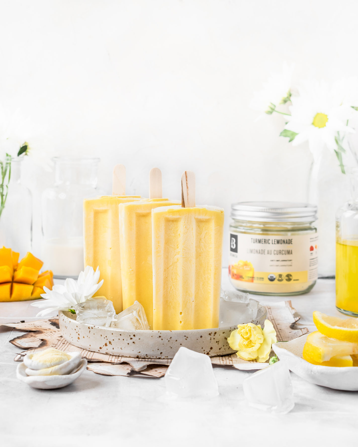 Creamy mango lemonade popsicles made with Botanica's Turmeric Lemonade powder. Refreshing, summer treat