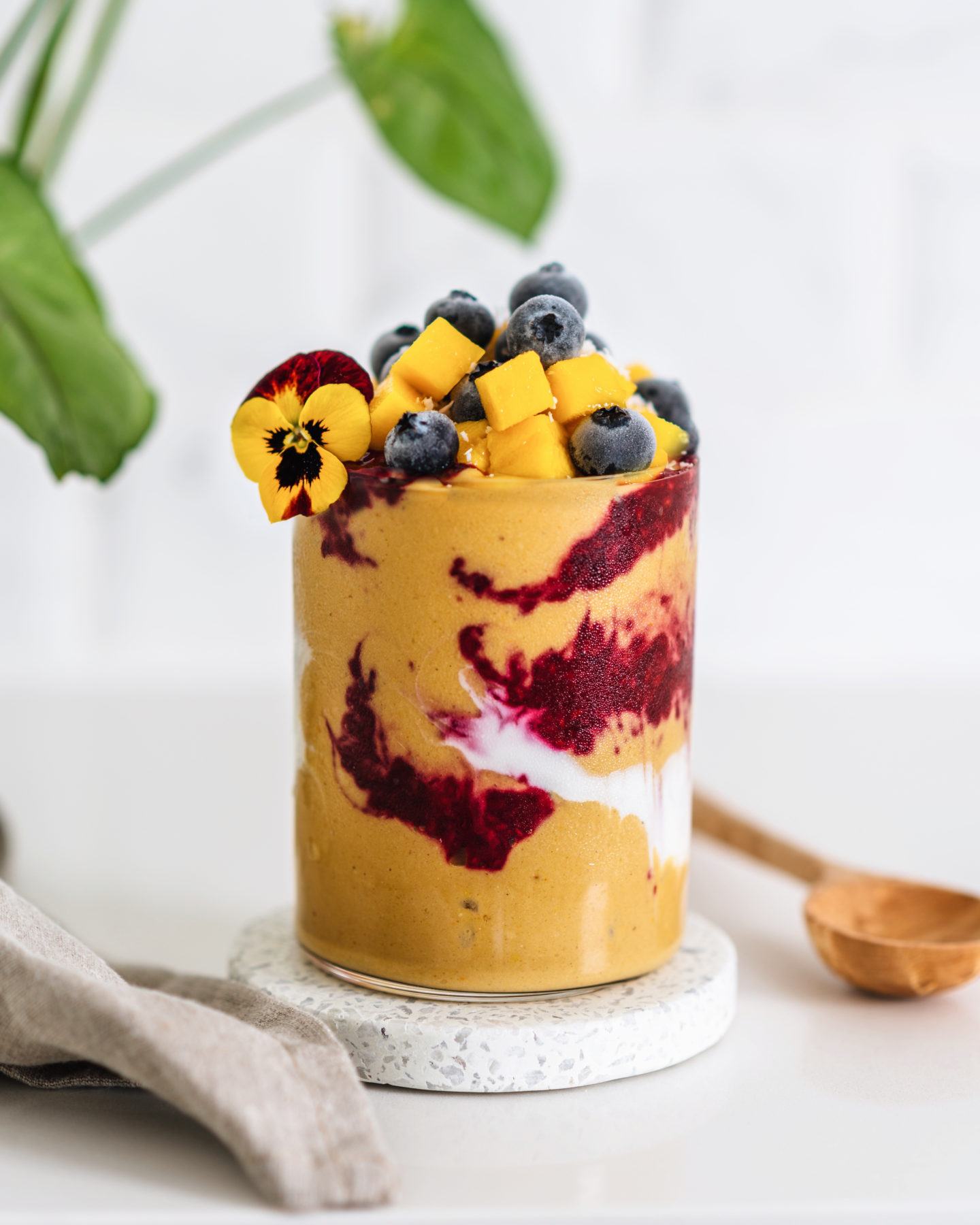 Brain Boosting Raspberry Mango Smoothie Parfait with fresh blueberries, mango, flowers, high protein. 